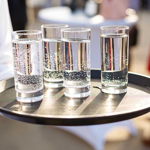Meeting table with water glasses and printed educational sheets for fluid intake awareness sessions
